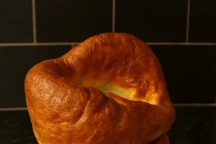 Delicious roast chicken served with Yorkshire pudding on a dinner plate.