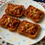 Plate of sardines on toast with herbs and lemon for a tasty meal.