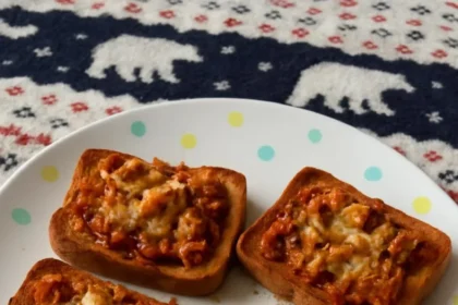 Plate of sardines on toast with herbs and lemon for a tasty meal.