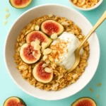 Toasted Coconut Baked Oatmeal in a bowl topped with coconut flakes and fruit