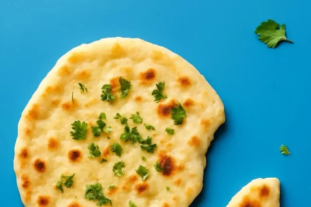 Freshly baked vegan naan served with curry on a wooden board