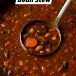 Bowl of veggie white bean stew filled with fresh vegetables and herbs