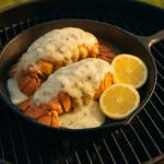 Delicious Cheesy Smoked Lobster topped with melted cheese and herbs