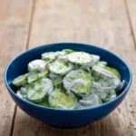 Creamy cucumber salad with sour cream served in a bowl