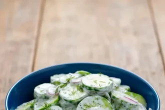Creamy cucumber salad with sour cream served in a bowl