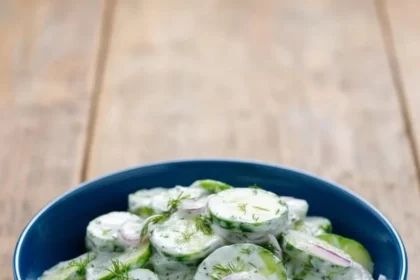 Creamy cucumber salad with sour cream served in a bowl