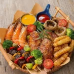 Delicious mixed grill platter featuring assorted meats and dipping sauces