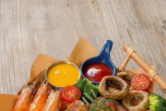 Delicious mixed grill platter featuring assorted meats and dipping sauces