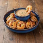 Smoky chipotle grilled shrimp served with zesty ranch sauce on a platter
