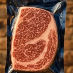 Plate featuring perfectly cooked Wagyu steak alongside fresh oysters.