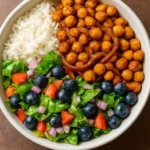 Ethiopian Berbere Spiced Chickpea Bowl topped with fresh herbs and veggies