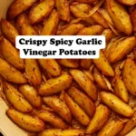 Roasted garlic cumin potatoes garnished with fresh herbs.