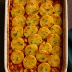 Creamy Mushroom Potato Casserole topped with herbs and cheese