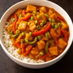 Peanut Butter and Miso Gochujang Tofu Stir-fry dish served with vegetables.