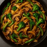 A vibrant plate of Vegan Thai Skillet Noodles with fresh vegetables and herbs.