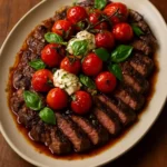 Balsamic Grilled Flank Steak Caprese garnished with fresh basil and tomatoes