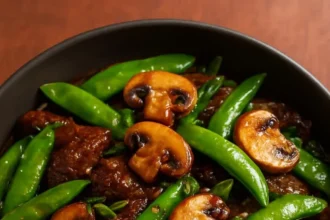 Beef stir-fry with snow peas and mushrooms in a vibrant dish