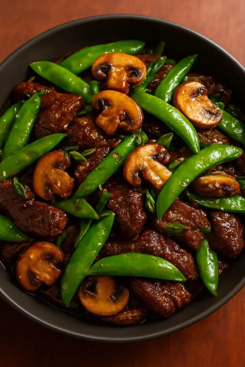 Beef stir-fry with snow peas and mushrooms in a vibrant dish