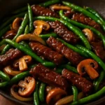 Black pepper beef stir-fry with vegetables in a skillet
