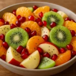 Citrus and fruit salad drizzled with honey-lime dressing on a plate