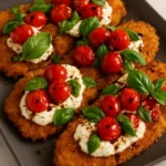 Crispy Italian basil chicken cutlets served on a plate with herbs