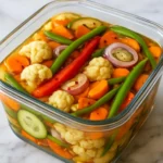 Jar of crunchy tangy refrigerator pickled vegetables with colorful veggies.