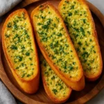 Deliciously baked garlic bread topped with herbs and melted butter