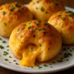 Freshly baked Garlic Cheddar Biscuits with herbs and melted cheese