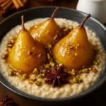 Honey-Spiced Pear Oatmeal topped with pistachios in a bowl