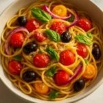 Colorful Italian spaghetti salad with vegetables and dressing