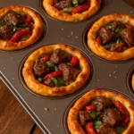 Mini steak and cheese cups served on a platter.