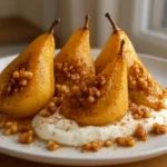 Pan-seared pears served with a drizzle of honey-yogurt sauce on a white plate.