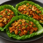 Savory chicken lettuce wraps served with colorful vegetables