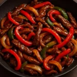 Spicy beef stir-fry with mushrooms and red peppers served in a bowl
