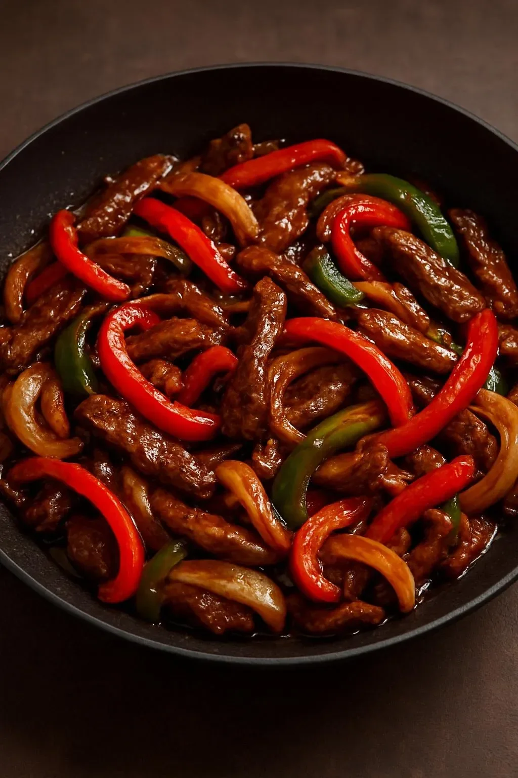 Spicy beef stir-fry with mushrooms and red peppers served in a bowl